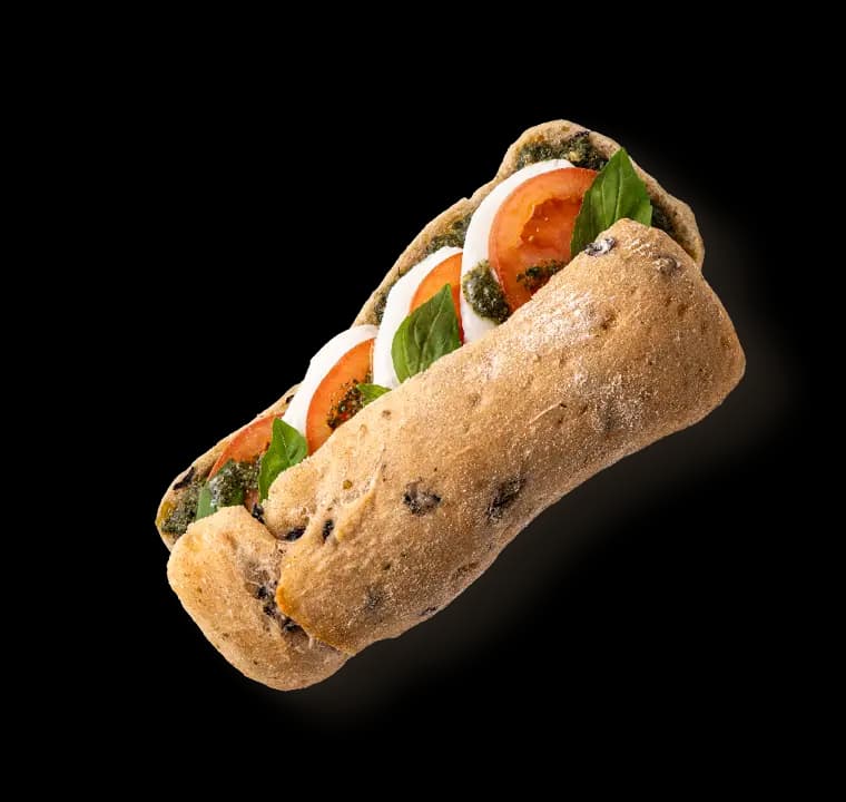 Abbildung eines Sandwich mit Tomaten und Basilikum.